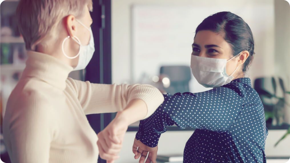 People wearing face masks practising social distancing