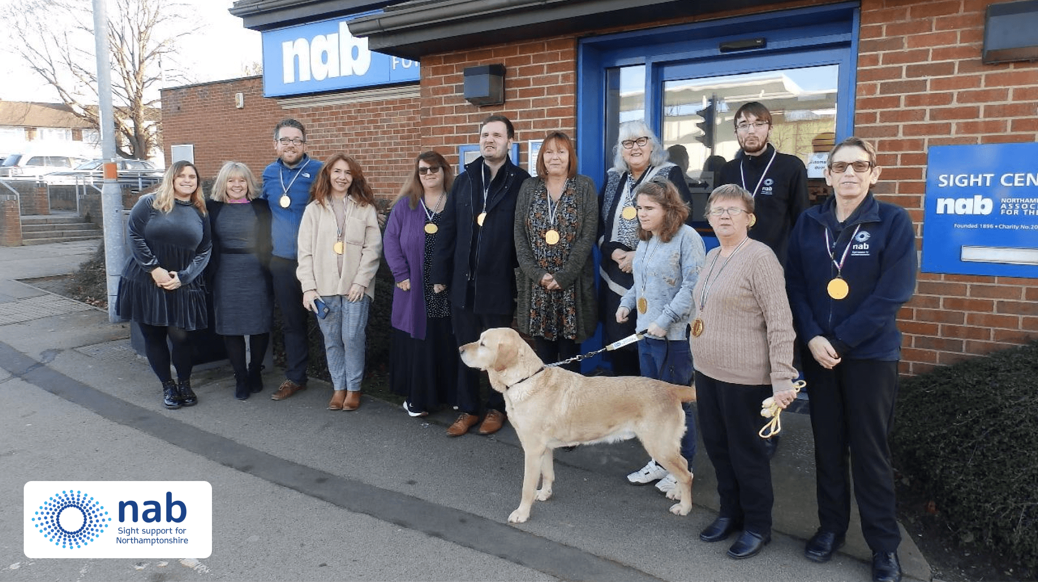 Photo of NAB employees with guide dog