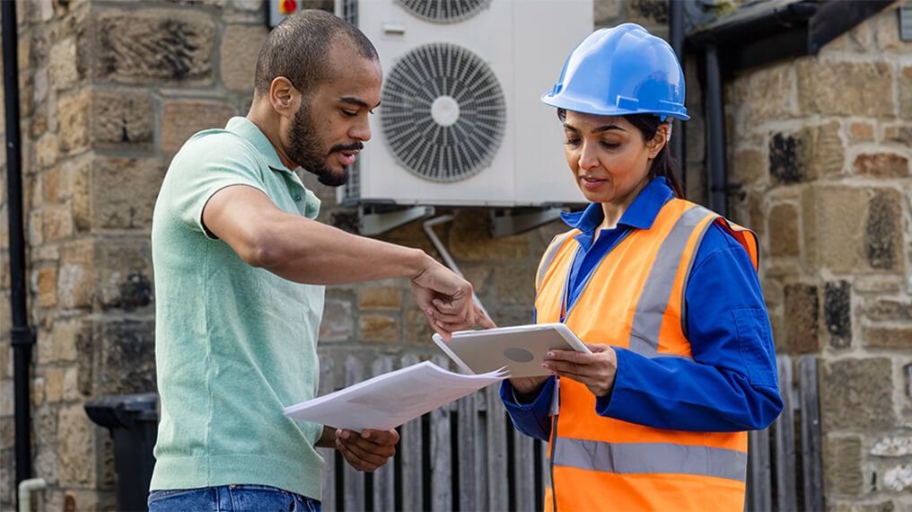 A healthy and safety inspector is discussing findings with a customer