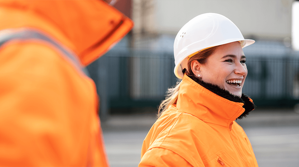Construction worker with a hard hat on smiling and happy at work