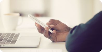 A person using their mobile phone at work to access HR tools